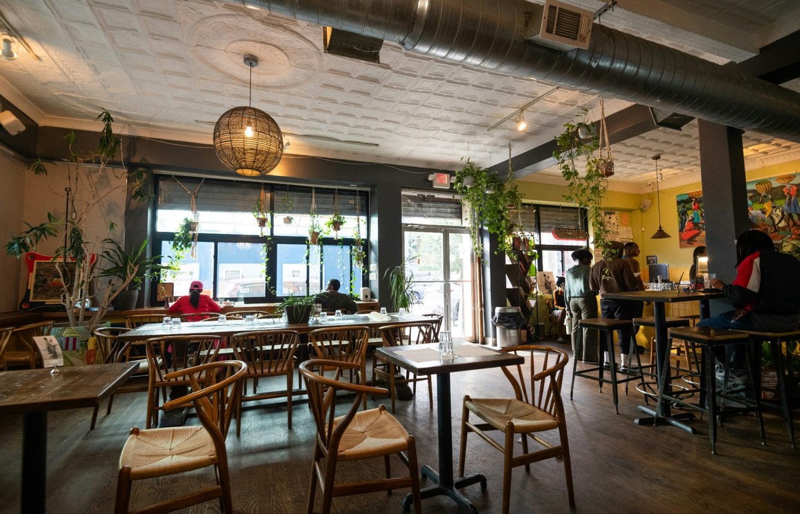 Restaurant dining room with timber tables and woven-seat chairs