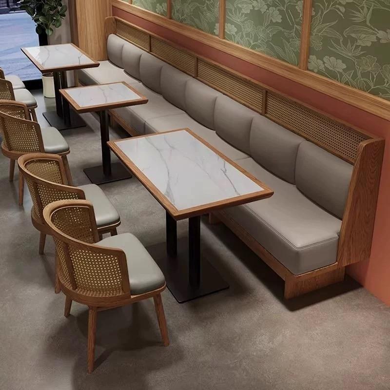 Banquette with Stone Tables and Rattan Chairs