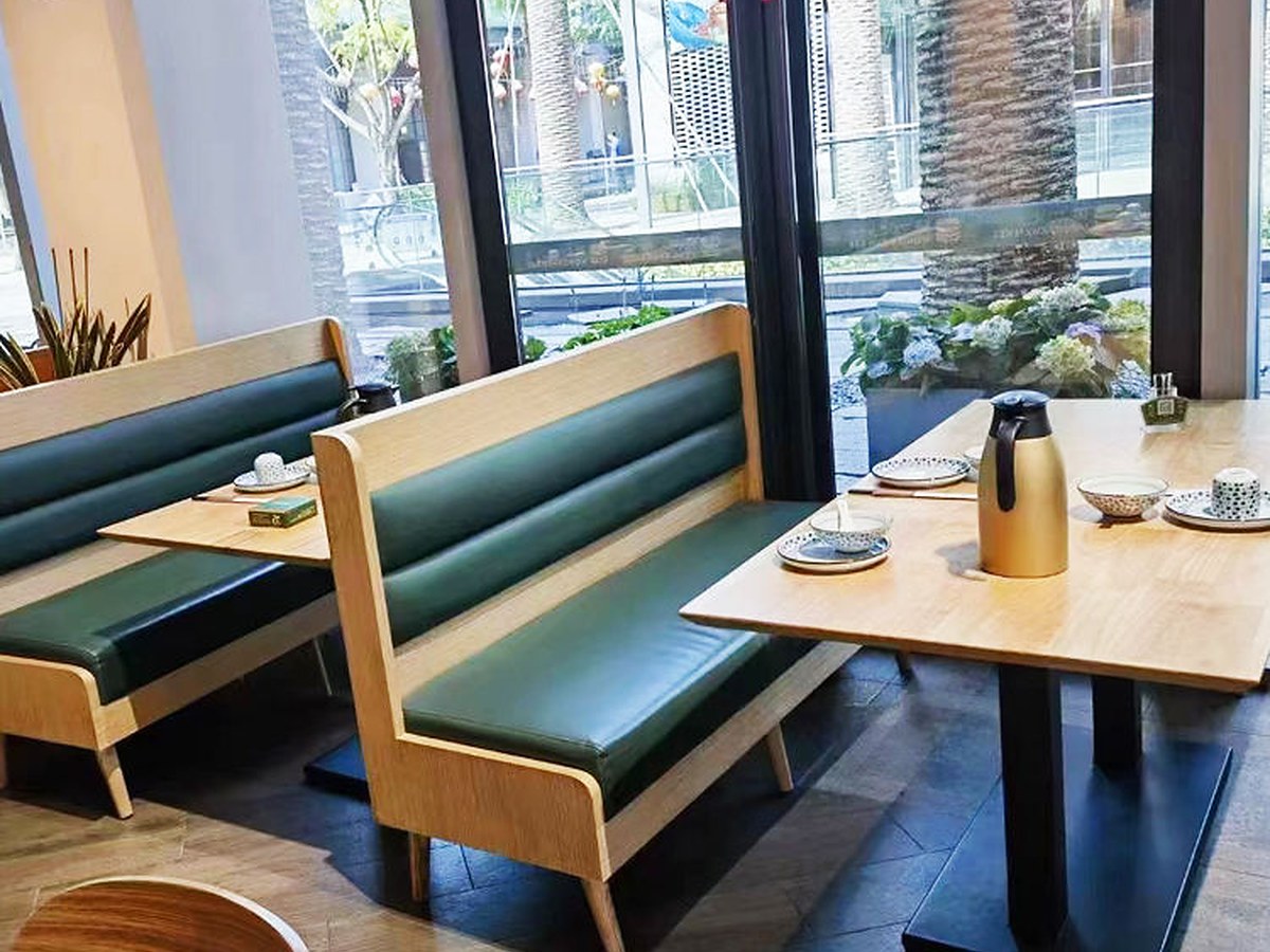 Banquette run: the long plate sits under the seat line, so nothing catches a foot at the aisle edge.