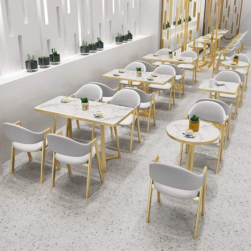White stone-effect tops on gold columns in a restaurant