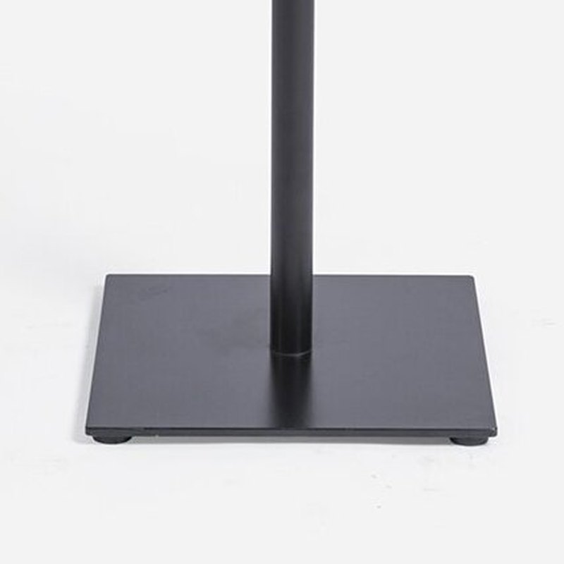Close view of the base plate and its adjustable feet on the floor