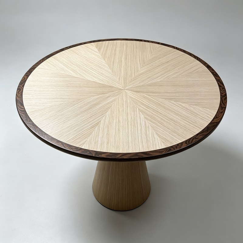 The same radial veneer top on a straight-grain timber pedestal instead of the figured one