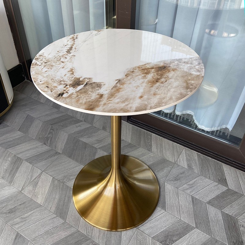 Round version of the same table with a brushed brass trumpet base