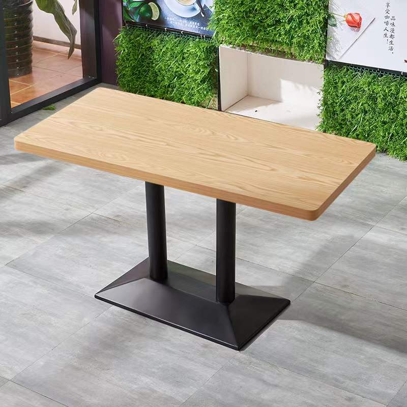 Rectangular version with an oak-grain top on twin columns, against the showroom wall