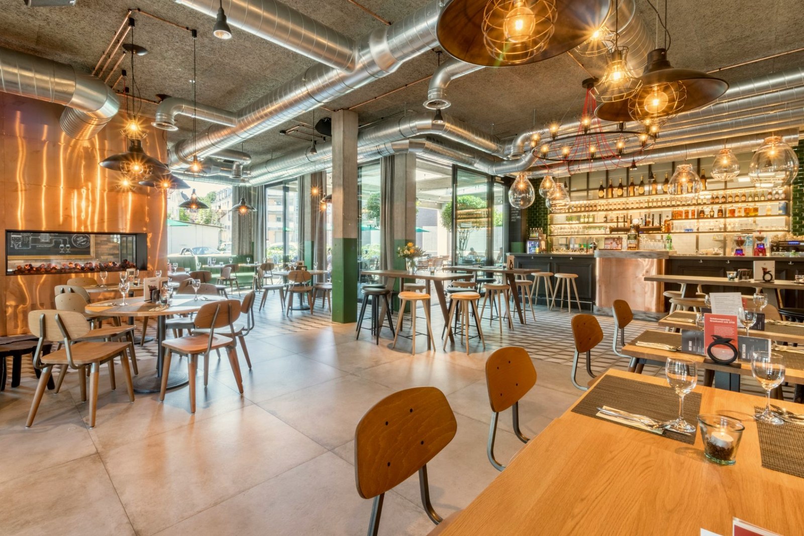 Full-service restaurant dining room fitted with timber tables and moulded plywood chairs